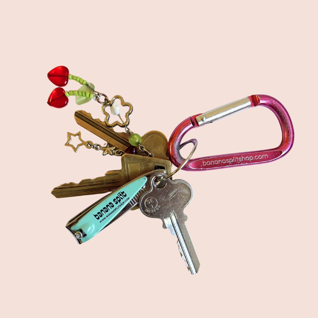 Keychain with keys, charms, and a Banana Split nail clipper attached