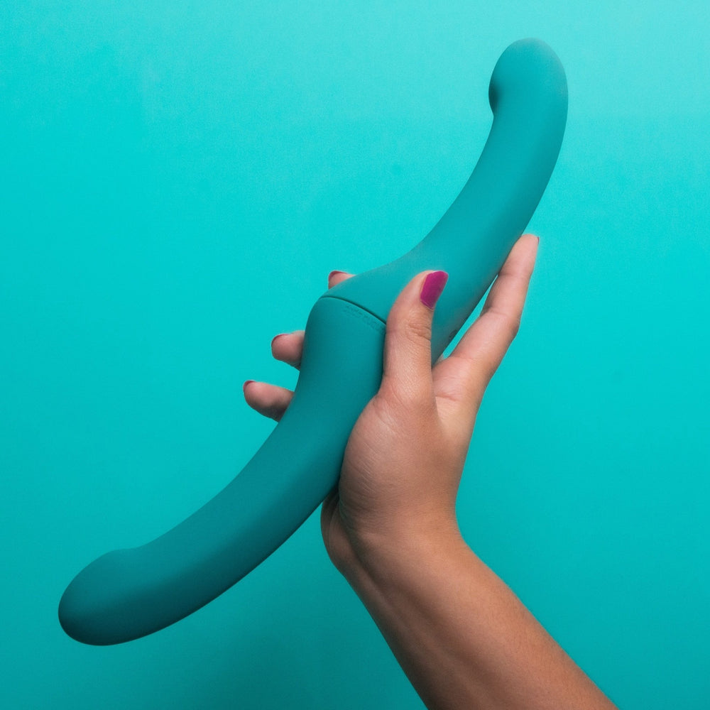 Photograph of the Bananarama blue modular partner vibrator set being held up against a blue backdrop.